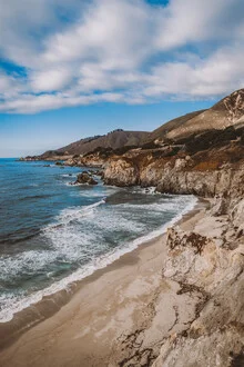 Landscape photo of California's coast featuring calm sea and gentle waves.