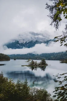 Photo art featuring a mountain lake shrouded in fog in a serene landscape