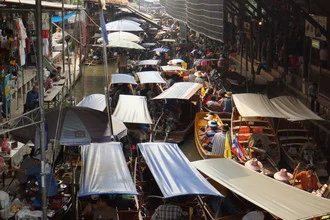 View of the floating market in Thailand with colorful boats and lively vendors.