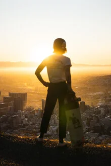 Skateboarder enjoys the view of the cityscape in Cape Town.