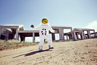 Photo art: a Protestonaut in front of an unfinished construction site in Greece