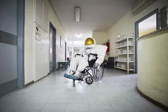 Photo art by Sophia Hauk: Protestonaut in a wheelchair, vibrant colors and contemplative mood
