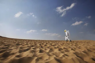 Astronaut in desert sand, solitude reflected in the vastness