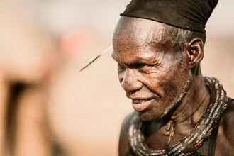 Portrait of a Himba chief in front of Epupa Falls in Namibia