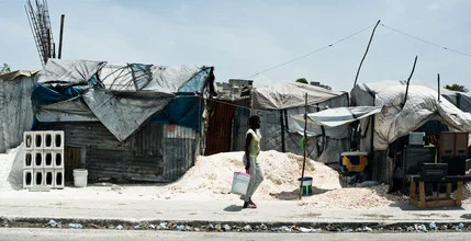 Street scene in Port-au-Prince with tents and people on the road