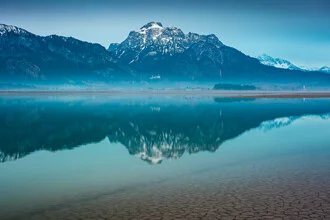 Dawn over Lake Forggensee with gentle mountains in the background