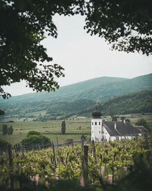Photo art by Daniel Öberg: serene church surrounded by green mountains in Austria