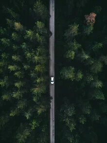 Aerial view of a road in Sweden, surrounded by green woods and gentle hills.