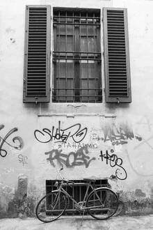 Wall art by Roman Becker: minimalist graffiti design featuring a bicycle in black and white
