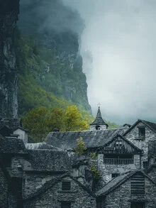 Gentle clouds over a calm village in the mountains, creating a peaceful atmosphere.
