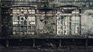 Photo art by Sascha Faber: broken windows in an abandoned building