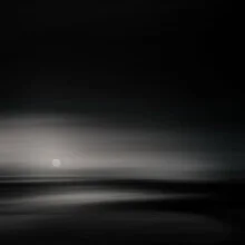 Black and white photo art: the moon over a calm landscape at night
