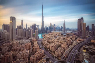 Evening skyline of Dubai with clouds and skyscrapers, calm atmosphere.